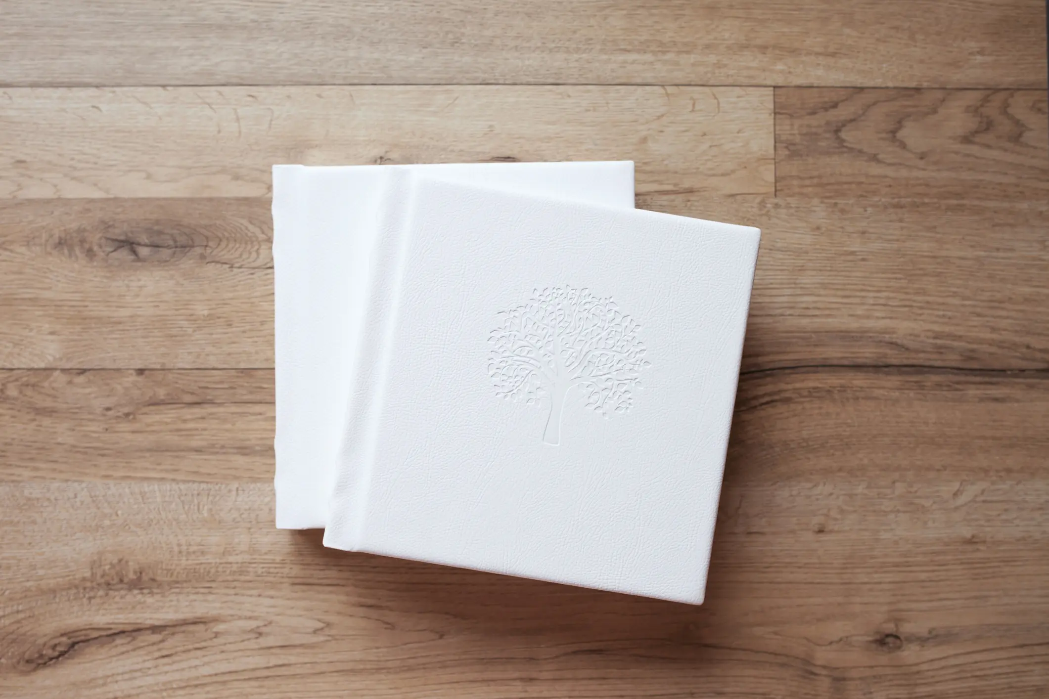 Photo book with leather cover. Stylish wedding or family photo album. Beautiful notepad or photobook with elegant embossing. Printing products. Individual products. Details